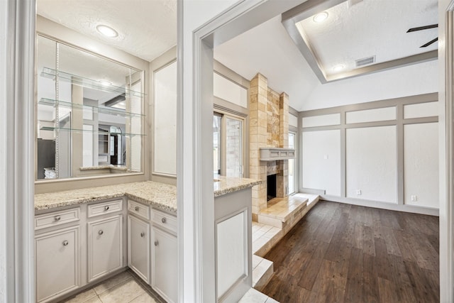 interior space featuring light stone counters, a textured ceiling, and light wood-type flooring