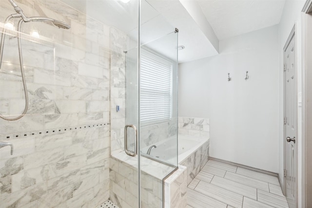 bathroom with separate shower and tub