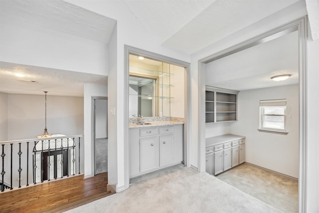 interior space with a textured ceiling, wood-type flooring, and lofted ceiling