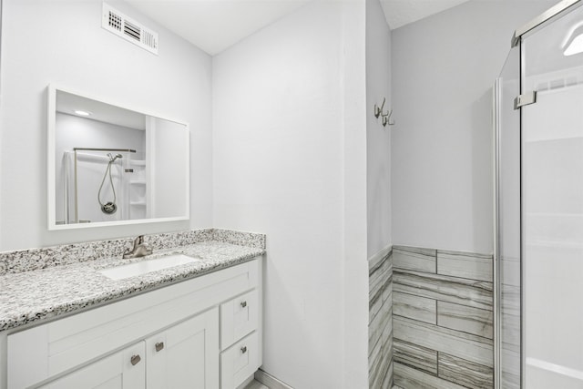 bathroom with vanity and walk in shower