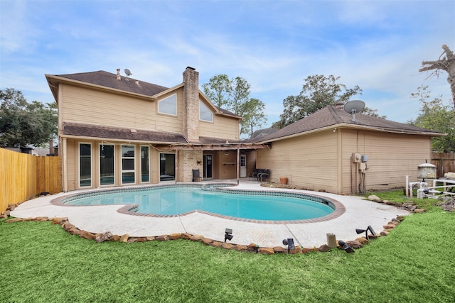 view of swimming pool featuring a patio area and a yard