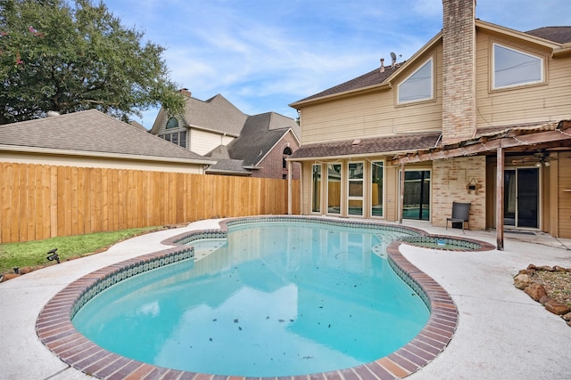 view of swimming pool with an in ground hot tub