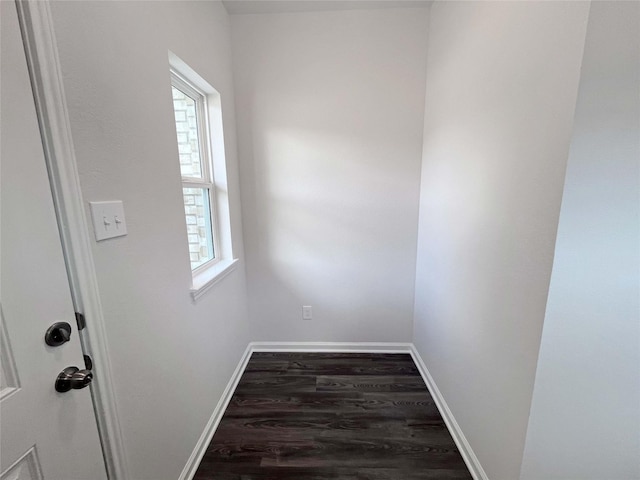 interior space with baseboards and wood finished floors