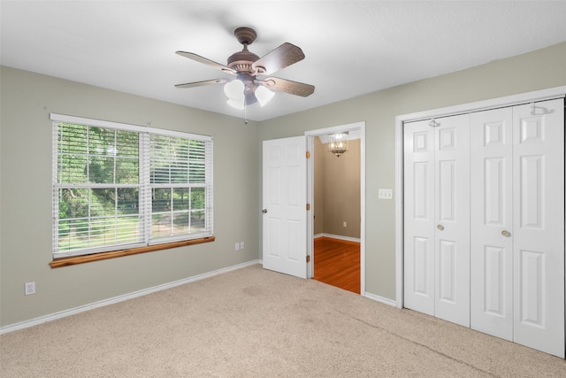 unfurnished bedroom with ceiling fan, light carpet, and a closet