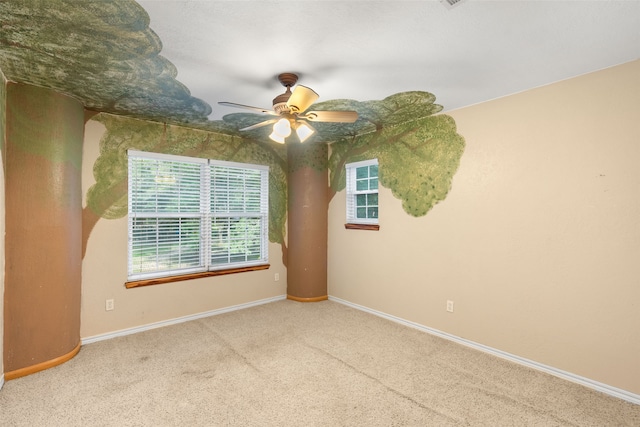 spare room featuring carpet flooring, ceiling fan, and a healthy amount of sunlight