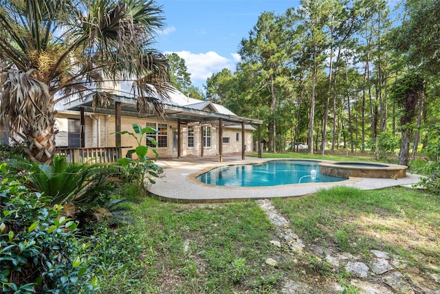 view of swimming pool featuring an in ground hot tub