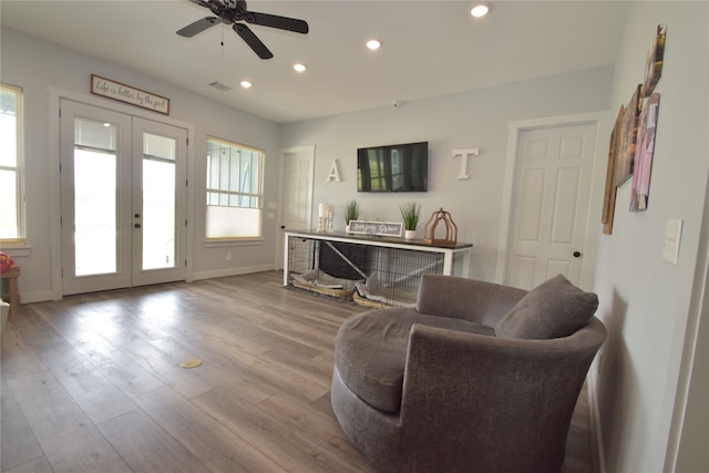 sitting room with ceiling fan, french doors, and light hardwood / wood-style flooring