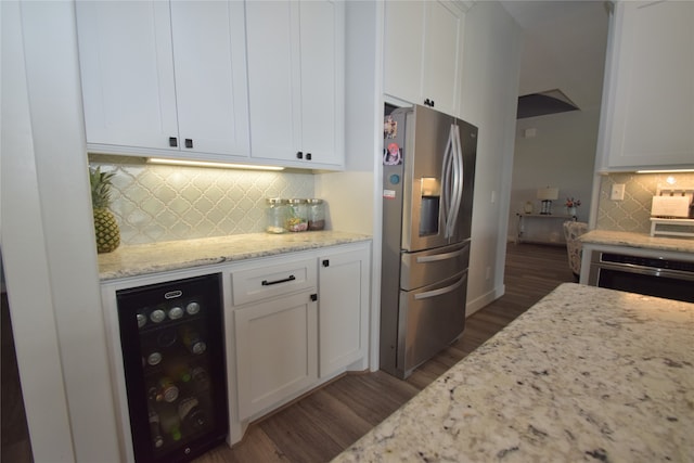 kitchen featuring white cabinets, stainless steel fridge, and beverage cooler