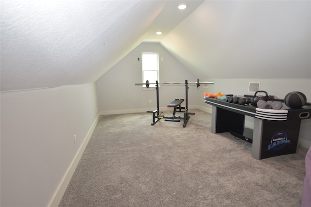 interior space with lofted ceiling, carpet floors, and a textured ceiling