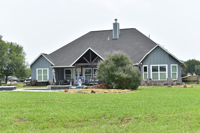 rear view of property with a yard