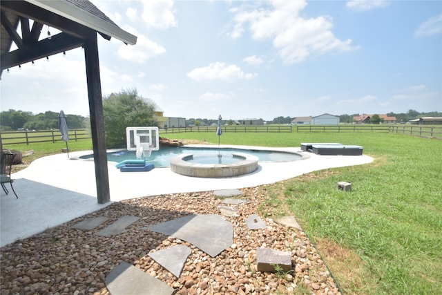 view of yard with an in ground hot tub and a rural view