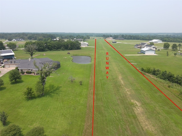 birds eye view of property with a rural view