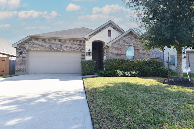 view of front facade with a front yard and a garage