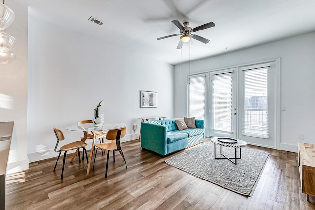 living room featuring ceiling fan, french doors, and hardwood / wood-style flooring