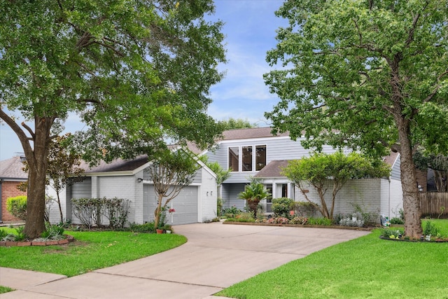 view of front of property with a front lawn and a garage