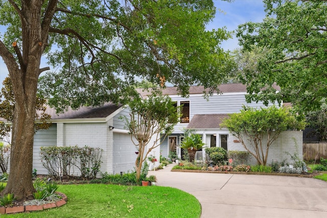 view of front of home with a garage and a front lawn