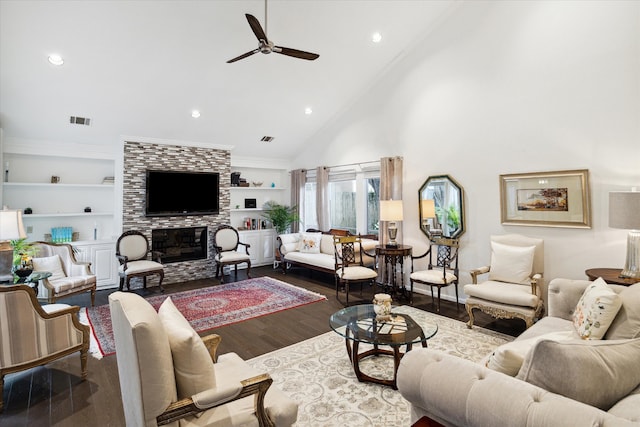 living room featuring high vaulted ceiling, ceiling fan, built in features, a fireplace, and wood-type flooring