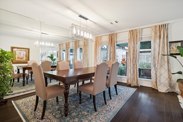 dining room with dark hardwood / wood-style floors and ornamental molding