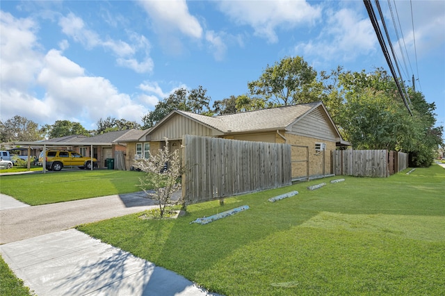 view of side of property with a yard