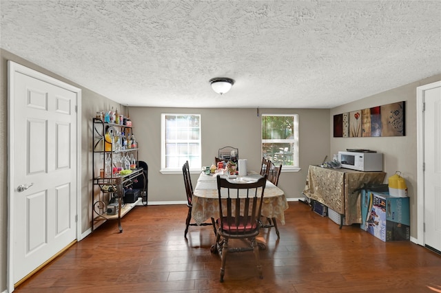 dining room featuring hardwood / wood-style floors, a textured ceiling, and plenty of natural light