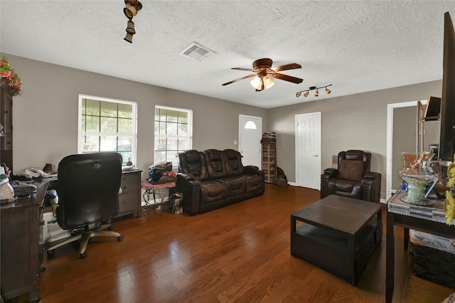 living room featuring a textured ceiling, ceiling fan, and dark hardwood / wood-style floors