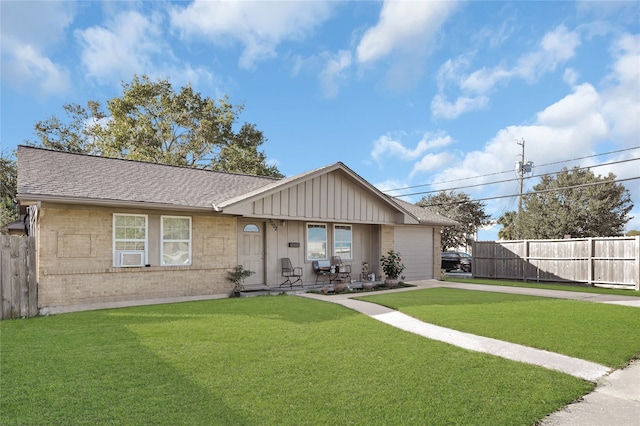 ranch-style home featuring a front lawn and a garage