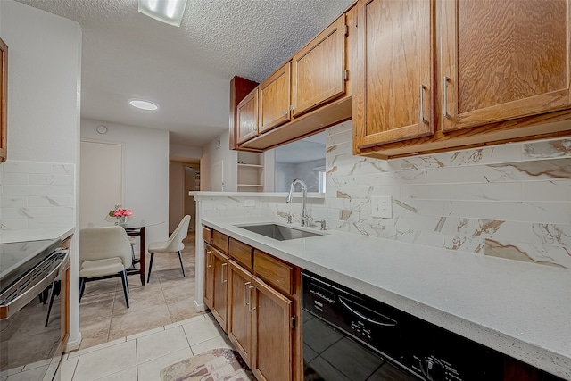 kitchen with dishwasher, sink, backsplash, stainless steel range with electric stovetop, and light tile patterned floors