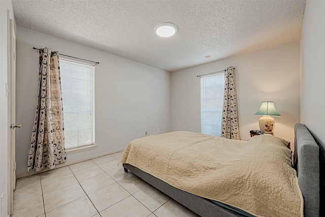 tiled bedroom with a textured ceiling