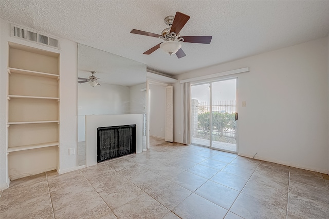 unfurnished living room with built in shelves, a textured ceiling, and ceiling fan