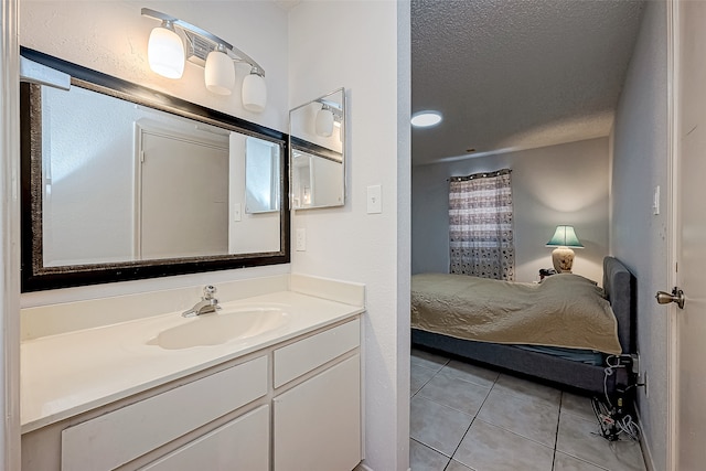 bathroom featuring a textured ceiling, vanity, and tile patterned floors