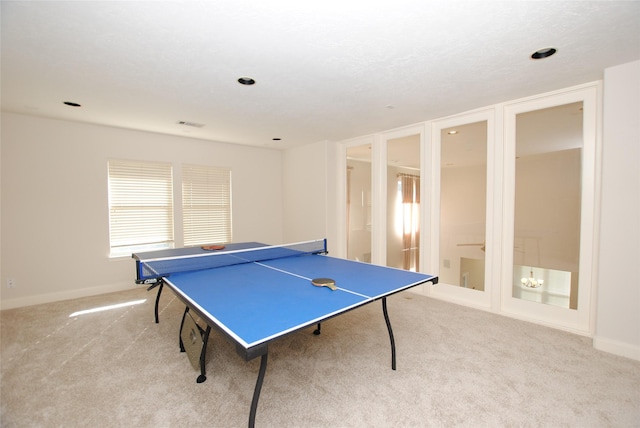 game room featuring light carpet