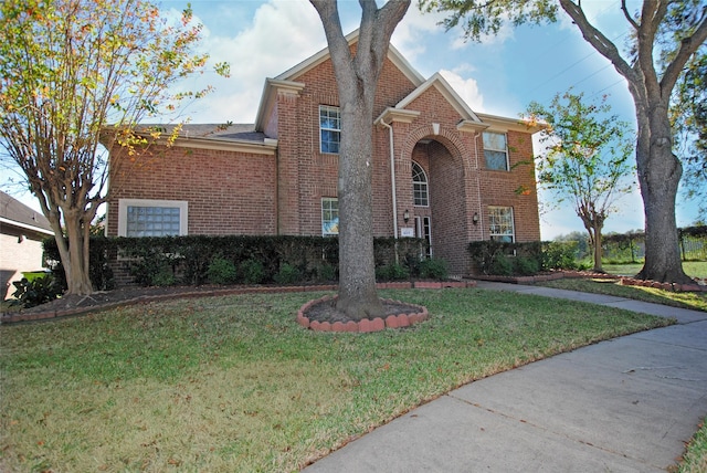 view of front of property with a front yard and brick siding