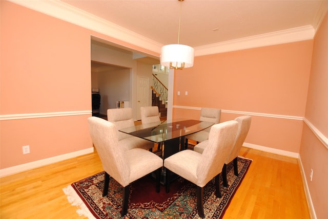 dining room featuring wood-type flooring and ornamental molding