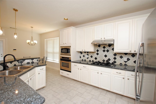 kitchen featuring pendant lighting, an inviting chandelier, white cabinets, sink, and stainless steel appliances