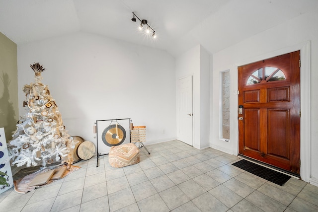 tiled entrance foyer with vaulted ceiling