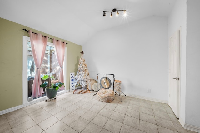 interior space featuring light tile patterned floors and lofted ceiling