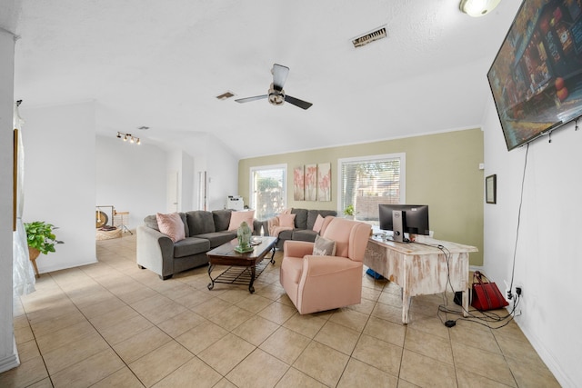 tiled living room with ceiling fan, crown molding, and lofted ceiling