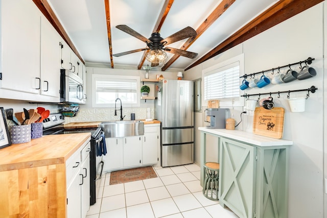 kitchen featuring ceiling fan, white cabinets, appliances with stainless steel finishes, and sink