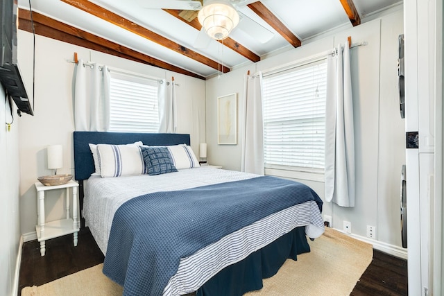 bedroom featuring ceiling fan, beamed ceiling, and hardwood / wood-style floors