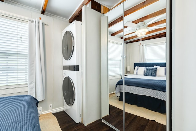 washroom with stacked washer / drying machine, ceiling fan, and dark hardwood / wood-style floors