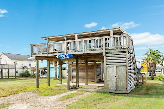 rear view of property with a yard and a wooden deck