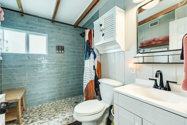 bathroom with toilet, vanity, and curtained shower