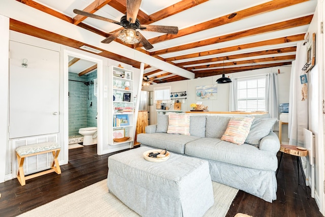 living room featuring dark hardwood / wood-style flooring and beam ceiling