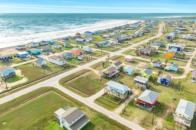 birds eye view of property featuring a water view and a beach view