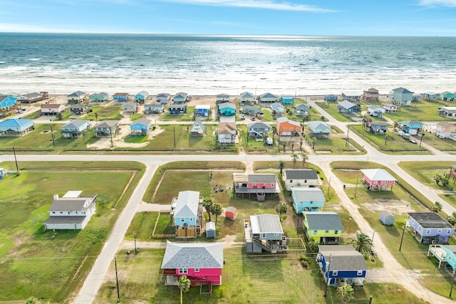 birds eye view of property featuring a beach view and a water view