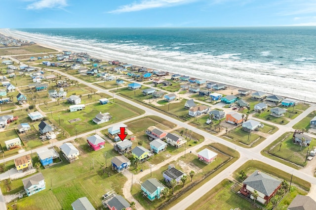 birds eye view of property featuring a view of the beach and a water view