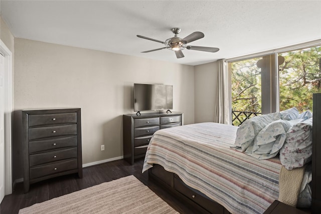 bedroom featuring ceiling fan, dark hardwood / wood-style flooring, and a textured ceiling