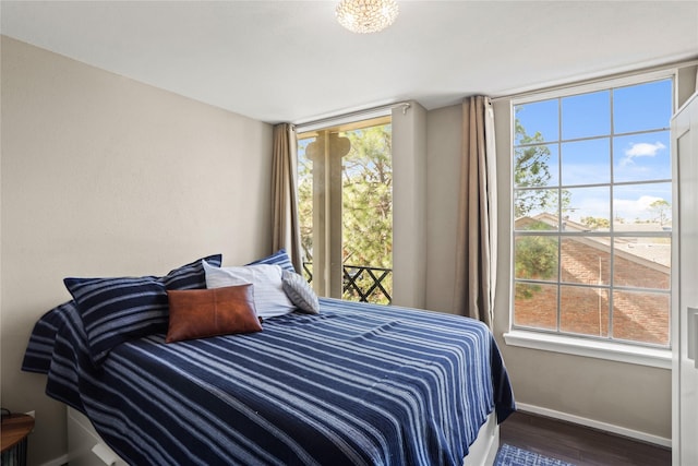 bedroom featuring hardwood / wood-style flooring and multiple windows