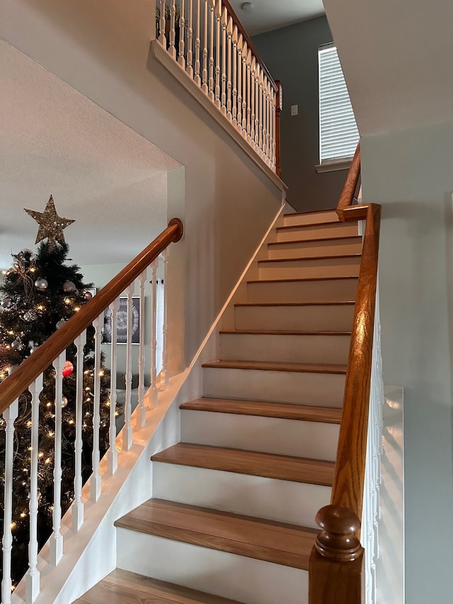 staircase with hardwood / wood-style flooring