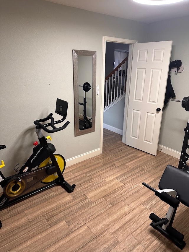 workout area with light hardwood / wood-style floors